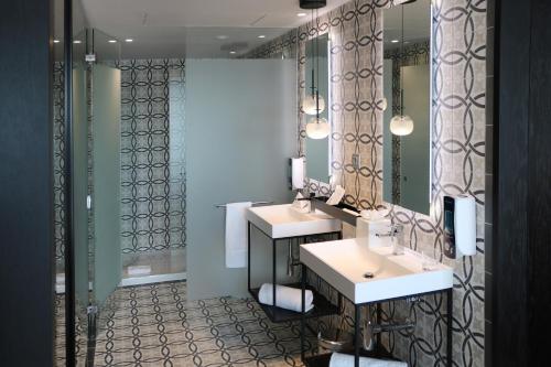 a bathroom with two sinks and a mirror at Hotel SB BCN Events 4* Sup in Castelldefels