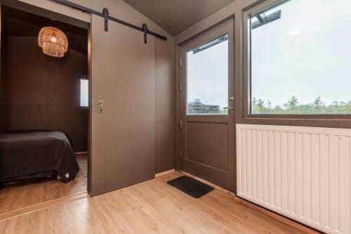 a room with a bed and a large window at Modern Summerhouse Views Outdoor Spaces Patio in Miðdalur