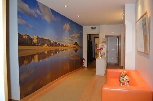 a hallway with a wall mural of a beach at Pension Kursaal in Donostia-San Sebastián