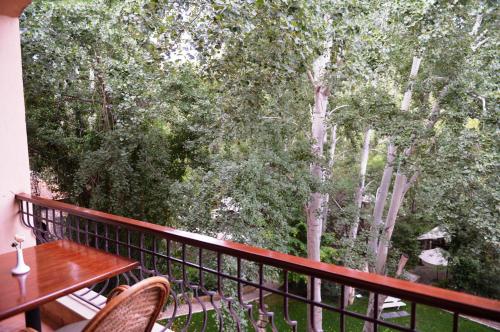 a balcony with a table and chairs and trees at Massabki Hotel in Chtaura