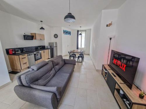 a living room with a couch and a kitchen at NETFLIX and CHILL, Maison duplex in Montargis