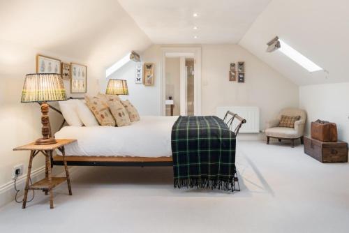 a bedroom with a bed and a table and a chair at Super Central - Georgian Double Upper Flat with Castle Views in New Town in Edinburgh