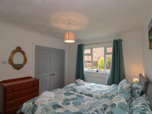 a bedroom with a bed and a window at Castelian in Bridlington