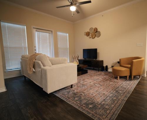 a living room with a couch and a chair at Charming 2 bedroom, 2 bath apartment in Austin