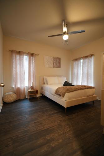 a bedroom with a bed and a ceiling fan at Charming 2 bedroom, 2 bath apartment in Austin