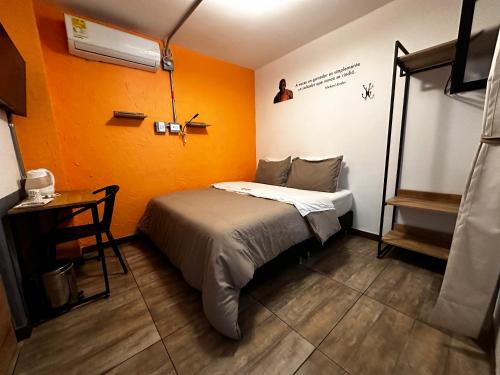 a small room with a bed and a table at CoLinkHouse Hotel in Medellín