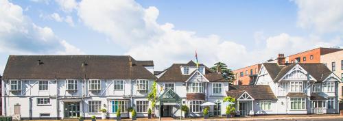 a large white building with a brown roof at County Hotel in Chelmsford