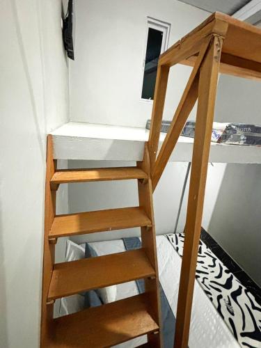 a ladder to a bunk bed in a room at Kost Harian Semarang Murah in Semarang