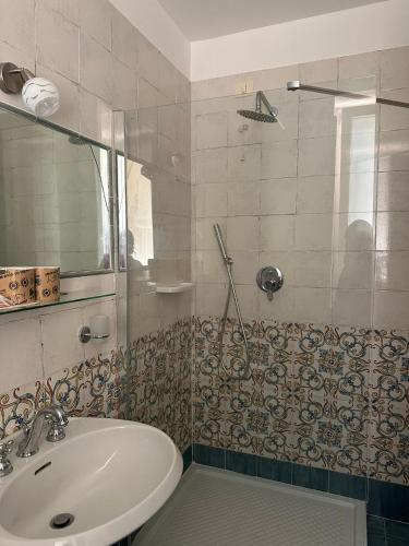 a bathroom with a sink and a shower at Hotel America in Marina di Camerota