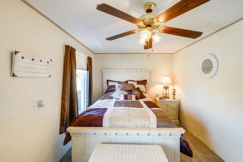 a bedroom with a bed and a ceiling fan at Pecos Vacation Rental Near Rodeo Arena! in Pecos