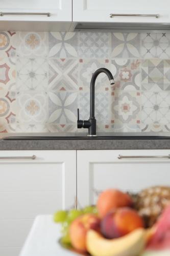 a plate of fruit in a kitchen with a sink at B&B Aquas in Sardara