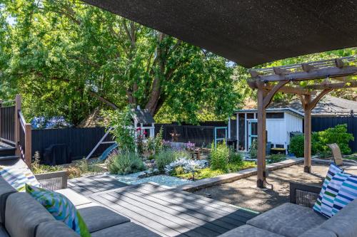 a backyard with a wooden pergola and a garden at Chic RV Retreat, Stunning Yard in Roseburg in Roseburg