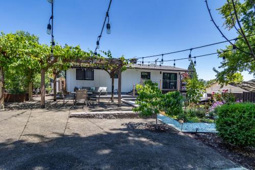 a backyard with a pergola and a house at Chic RV Retreat, Stunning Yard in Roseburg in Roseburg