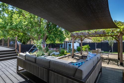 a patio with a couch under a pergola at Chic RV Retreat, Stunning Yard in Roseburg in Roseburg