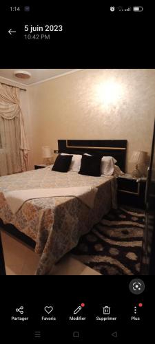 a bedroom with a large bed with white sheets and pillows at المضيق حي القلعة شارع الإمام مالك رقم 62 in M'diq