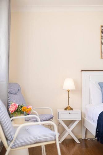 a bedroom with a bed and a chair and a table at Homy Self Contained Unit Sunnybank CBD Street Parking in Brisbane