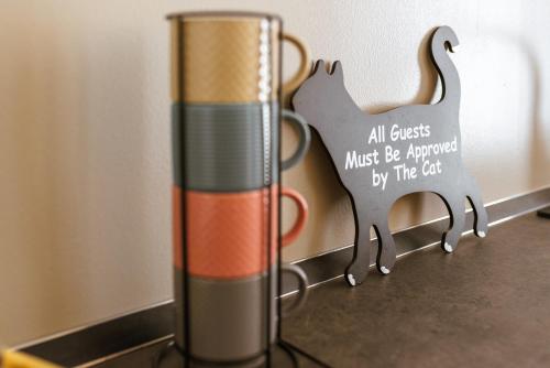 a vase with a sign that says all objects must be approved by the cat at Borgo Cavour Luxury Apartments - Centro storico in Fano