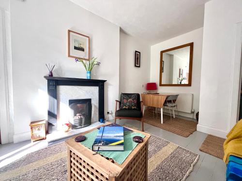 a living room with a fireplace and a table at Garden Flat in Edinburgh
