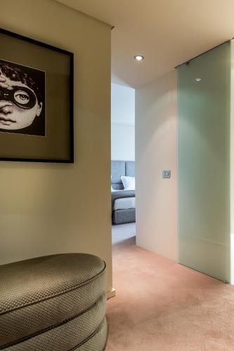 a living room with a couch and a picture on the wall at 4615 Hotel in Felgueiras