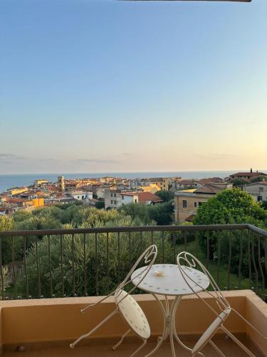 a table and chairs on a balcony with a view at Hotel America in Marina di Camerota