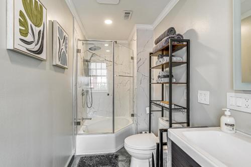 a bathroom with a shower and a toilet and a sink at Charming Apartment in Downtown Winston-Salem! in Winston-Salem
