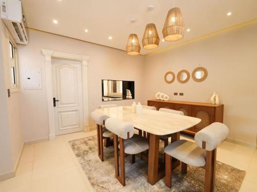 a dining room with a table and chairs at 3 BDR Serviced Pyramid-View APT in Giza, Egypt in Cairo