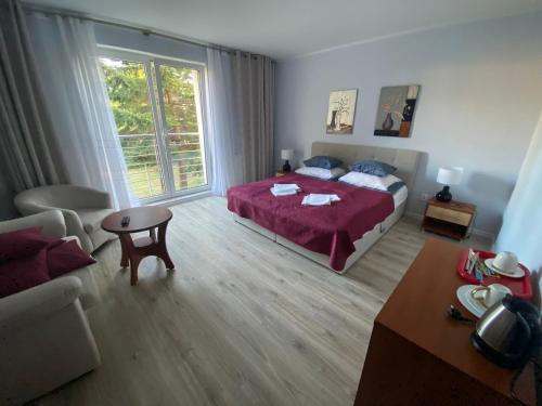a bedroom with a bed with a red blanket at Altona in Władysławowo