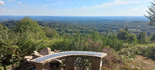 a stone bench sitting on top of a hill at Le paradis caché du Limousin Gite Camino 4 pers in Jabreilles-les-Bordes