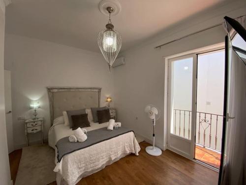a bedroom with a bed with two stuffed animals on it at Precioso Ático de Lujo en Calle Ancha in Sanlúcar de Barrameda