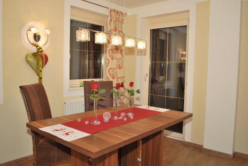 a dining room table with flowers in vases on it at Landhaus Notburga in Gries im Sellrain