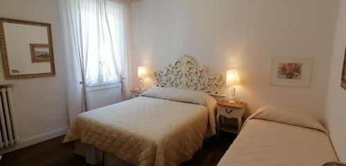a bedroom with two beds and a mirror at L'Angolo di Firenze - The Florence Corner in Florence