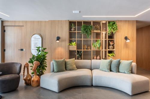 a living room with a couch and some plants at Icon Hotel by Welkom in João Pessoa