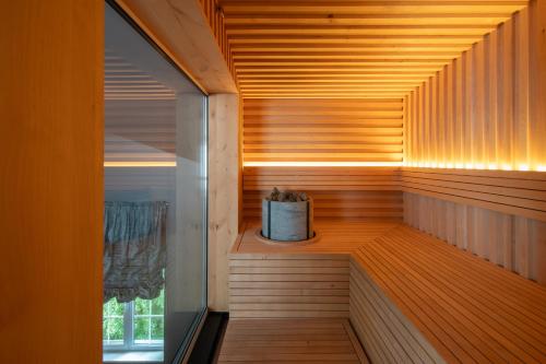 a sauna with a box on a wooden floor at Amsterdam Plaza Hotel & SPA in Palanga