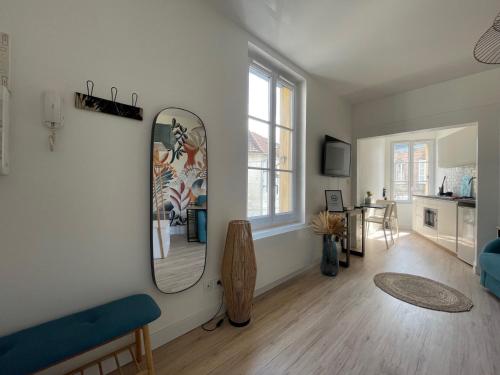 a living room with a mirror on the wall at ​Cœur de ville ! Cœur de l'Oise​​ ! Moderne & fonctionnel​ in Clermont