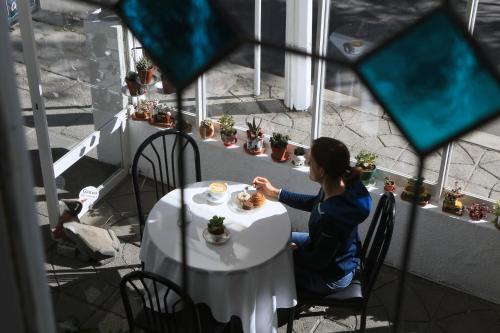 a woman sitting at a table with a plate of food at Casa Fusion Hotel Boutique in La Paz