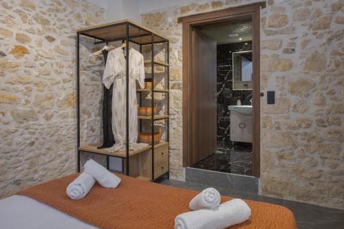 a bedroom with a bed and a shower with a mirror at Anassa Luxury Apartment 13 in Heraklio Town