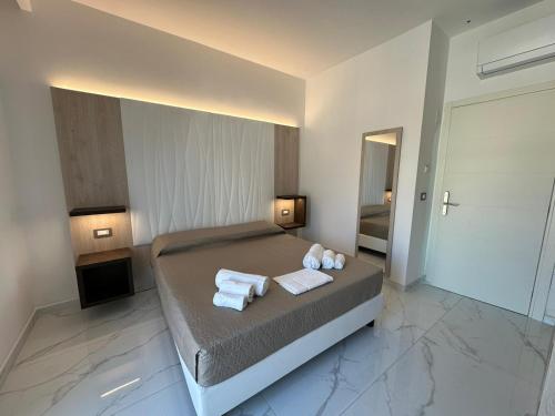a bedroom with a bed with towels on it at Sea Garden City in Termoli
