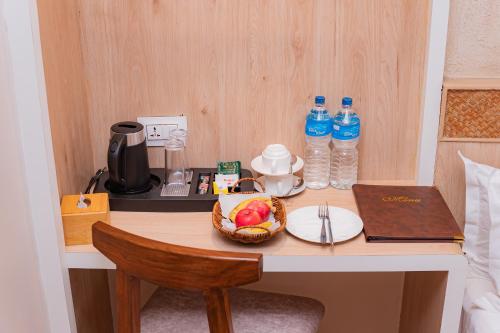 a desk with a bowl of fruit and water bottles at Hotel Vistara in Kathmandu