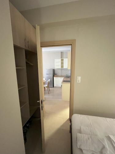 a room with a door open to a bedroom at Astron Apartments in Keramotí