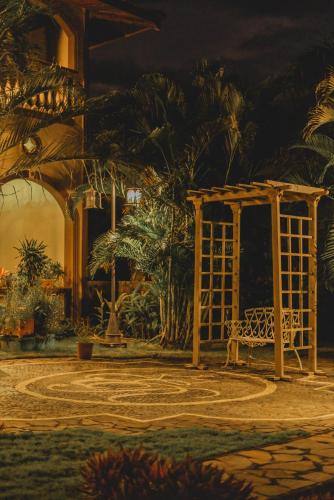 a park with a bench and a gazebo at Hotel El Reith Lake in Granada