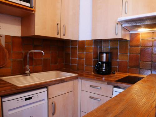 Il comprend une cuisine équipée d'un évier et d'une cafetière. dans l'établissement Résidence LE BASTION I - 2 Pièces pour 5 Personnes MAE-9844, à Aime La Plagne
