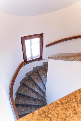 a spiral staircase in a house with a window at Apartmány Nábřeží Sušice nad Otavou in Sušice