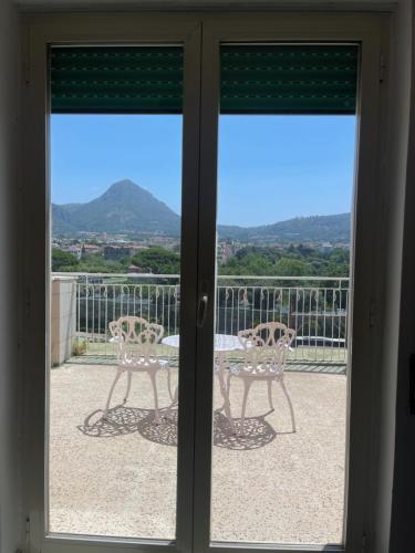 a sliding glass door with a table and chairs on a balcony at Hotel Klein Wien in Piano di Sorrento