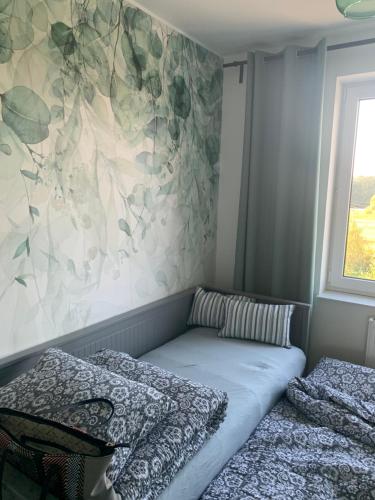 a bedroom with two beds and a wall at Smile 2 in Tomice