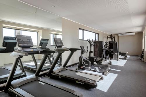 a gym with several treadmills and cardio machines at Top Rentals Nuñez in Buenos Aires