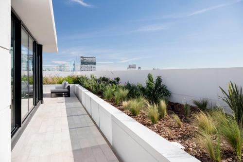an external view of a white building with plants at Top Rentals Nuñez in Buenos Aires