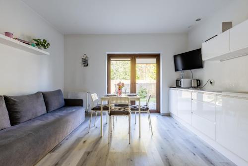 a living room with a couch and a table at PlumTree Holiday Apartment in Gdańsk