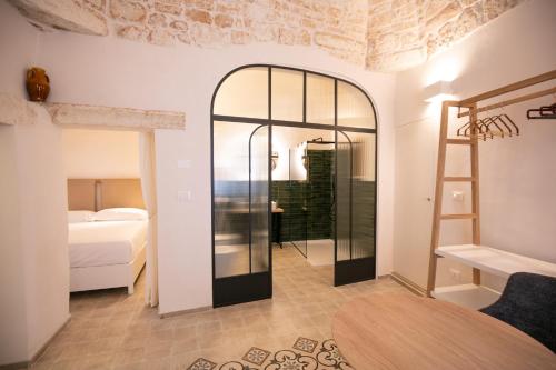 a room with a bed and a glass door at Casa Rina in Ostuni