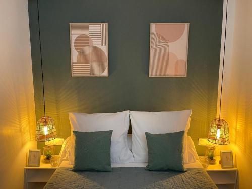 une chambre avec un lit avec trois tableaux au mur dans l'établissement Chic Cocon in Rouen, à Rouen