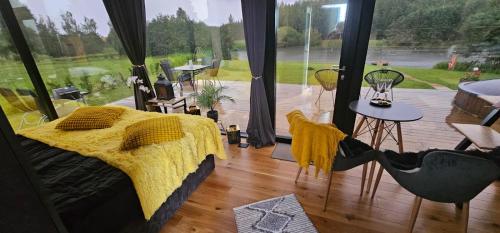 a bedroom with a bed and a view of a patio at Pöögle Järvemaja in Pöögle